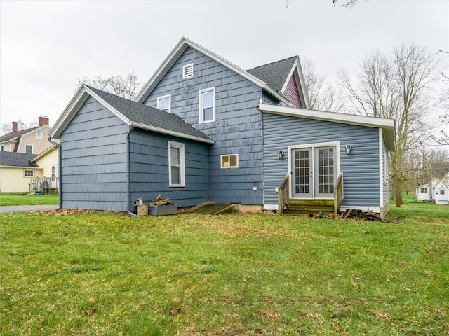 rear view of property featuring a yard