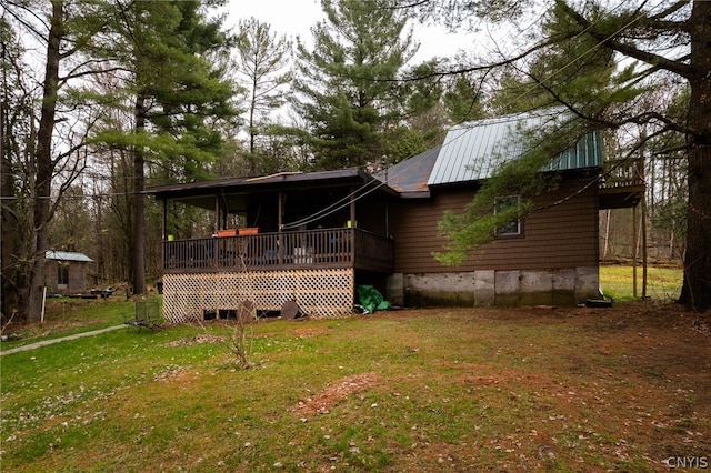 view of front facade with a wooden deck and a front yard