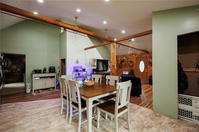 dining space with lofted ceiling with beams and light tile floors