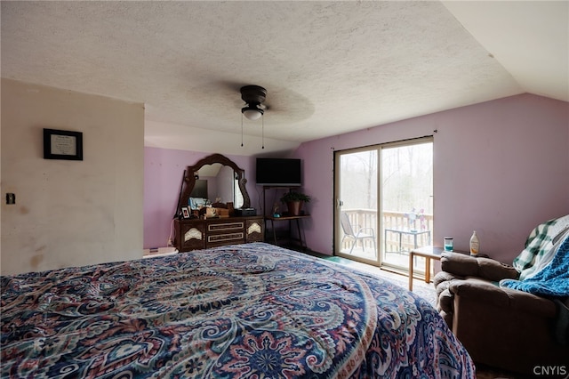 bedroom featuring vaulted ceiling, ceiling fan, access to outside, and a textured ceiling