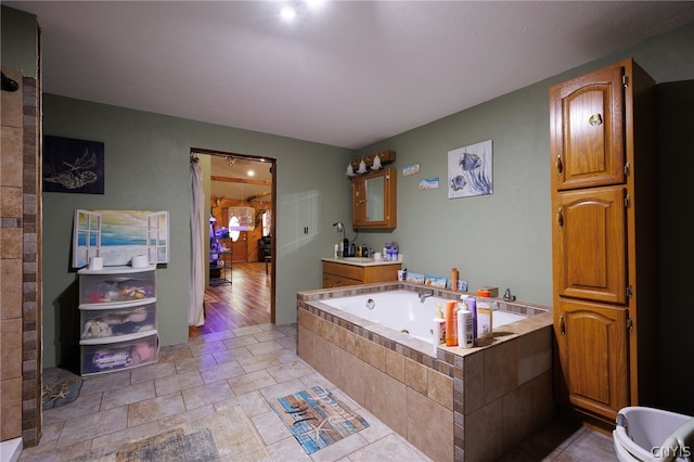 bathroom featuring wood-type flooring, independent shower and bath, and vanity