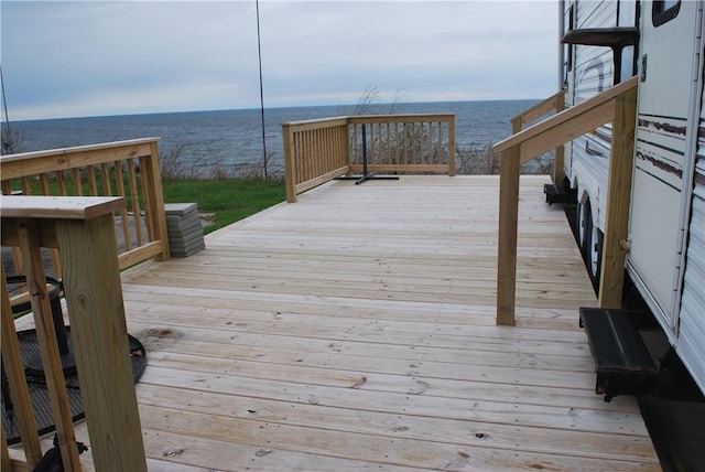 dock area featuring a deck with water view