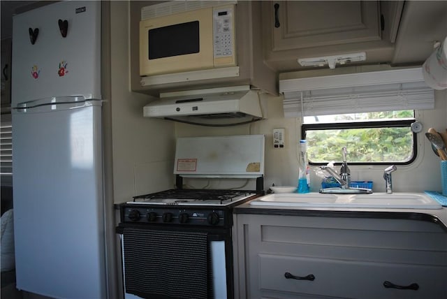 kitchen featuring sink, extractor fan, and white appliances