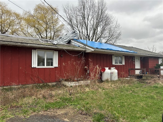 view of side of property with a yard