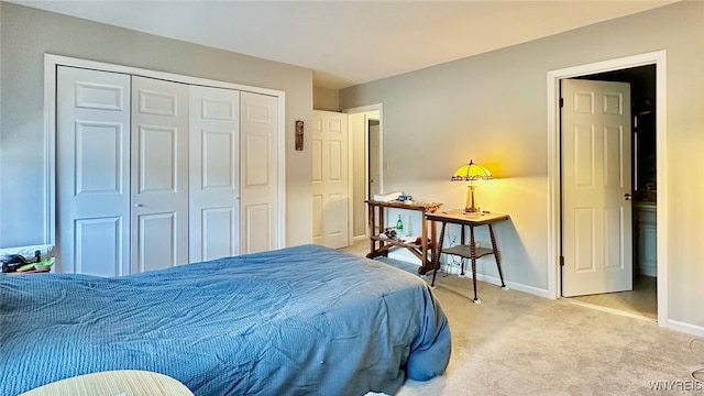 bedroom with light carpet and a closet