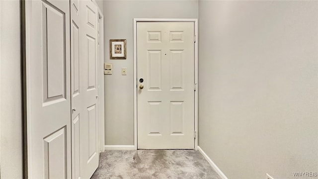 entryway with light colored carpet