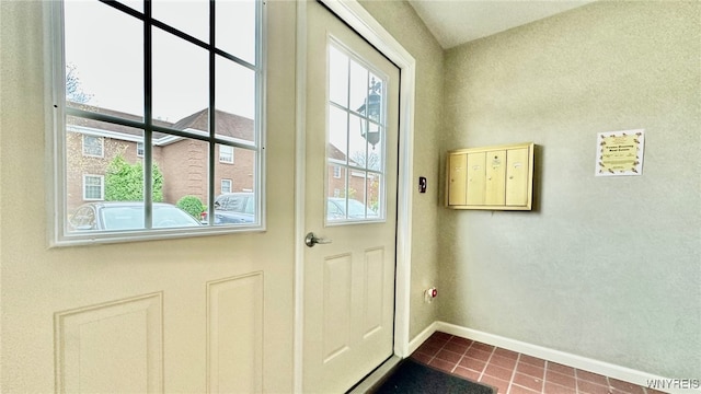 entryway featuring dark tile patterned floors