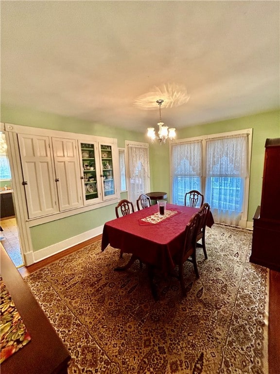 dining room featuring an inviting chandelier and wood-type flooring