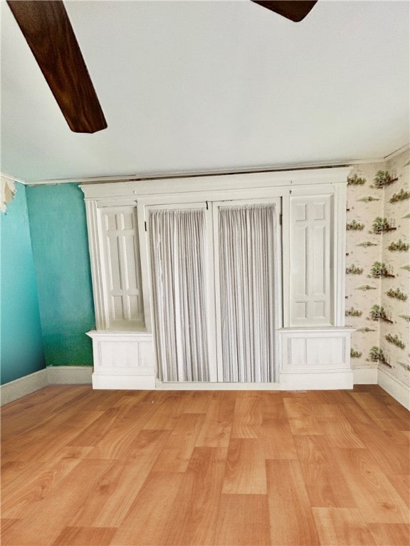 empty room with ceiling fan and light wood-type flooring