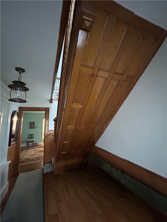 bonus room with wooden walls and hardwood / wood-style floors