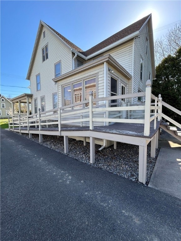 back of house with a wooden deck