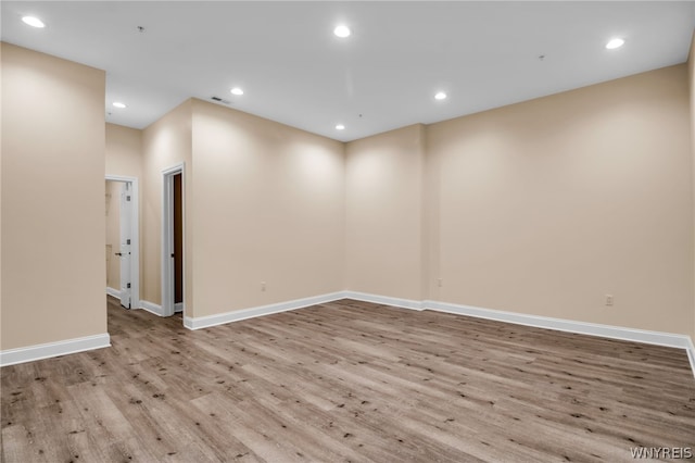 spare room with hardwood / wood-style floors