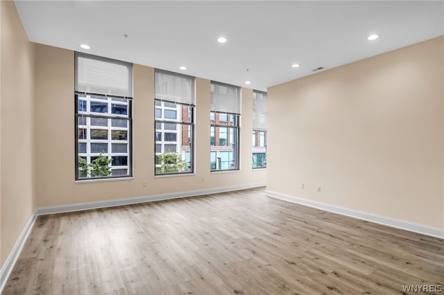 spare room with hardwood / wood-style floors