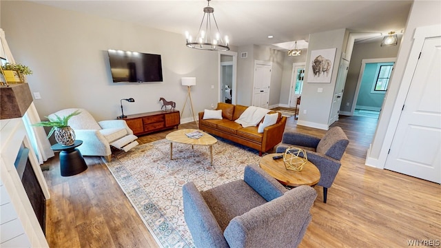 living room featuring a chandelier and hardwood / wood-style flooring