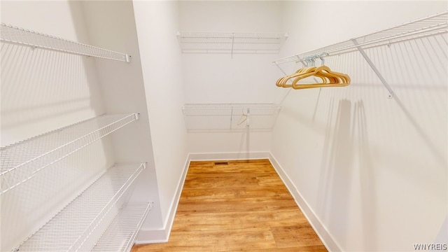 walk in closet featuring light hardwood / wood-style floors