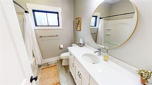 full bathroom with vanity with extensive cabinet space, toilet, and shower / bath combo with shower curtain