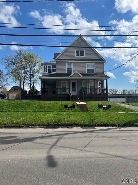 view of front facade with a front lawn and a porch