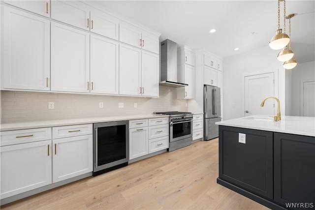 kitchen featuring wall chimney exhaust hood, premium appliances, beverage cooler, tasteful backsplash, and light hardwood / wood-style floors