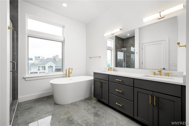 bathroom featuring plus walk in shower, oversized vanity, dual sinks, and tile flooring