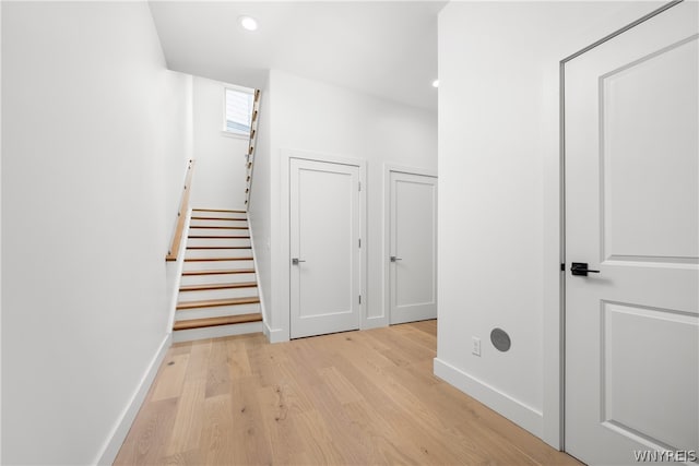 corridor with light hardwood / wood-style flooring