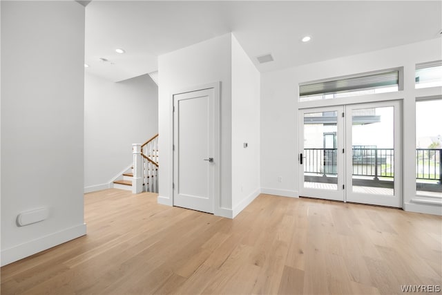 entrance foyer with light hardwood / wood-style flooring and french doors