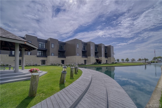 dock area featuring a water view and a lawn