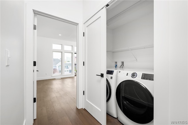 washroom featuring dark hardwood / wood-style flooring, washer and dryer, and hookup for a washing machine