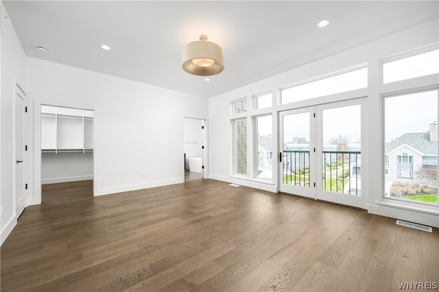 unfurnished living room featuring dark hardwood / wood-style floors