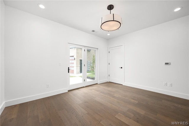 unfurnished room featuring dark hardwood / wood-style flooring