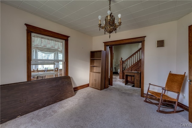 living area with an inviting chandelier and carpet