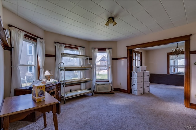 interior space featuring carpet flooring and an inviting chandelier