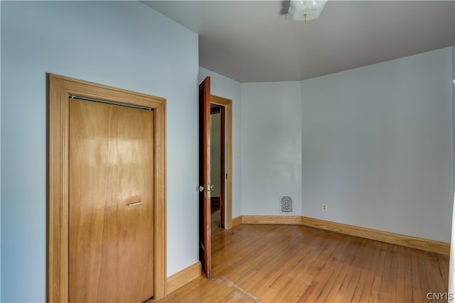 unfurnished bedroom featuring a closet and light hardwood / wood-style flooring