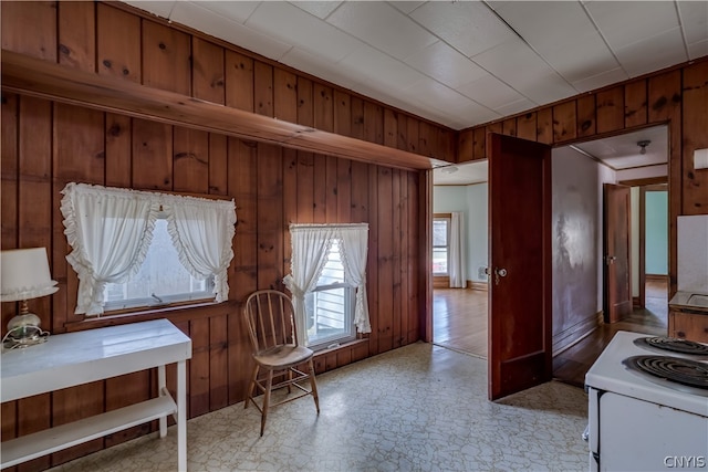 sitting room with wood walls and light tile floors