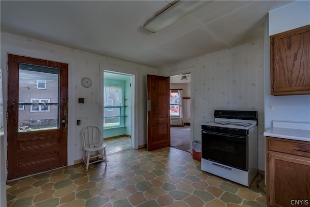 kitchen with tile flooring and white range with electric stovetop