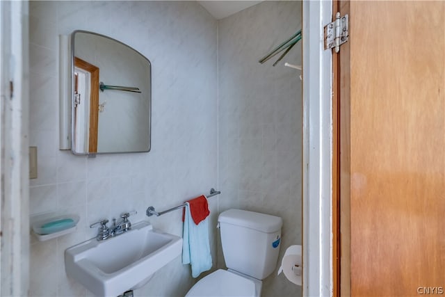 bathroom featuring tile walls, sink, backsplash, and toilet