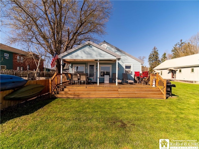 back of property featuring a yard and a wooden deck