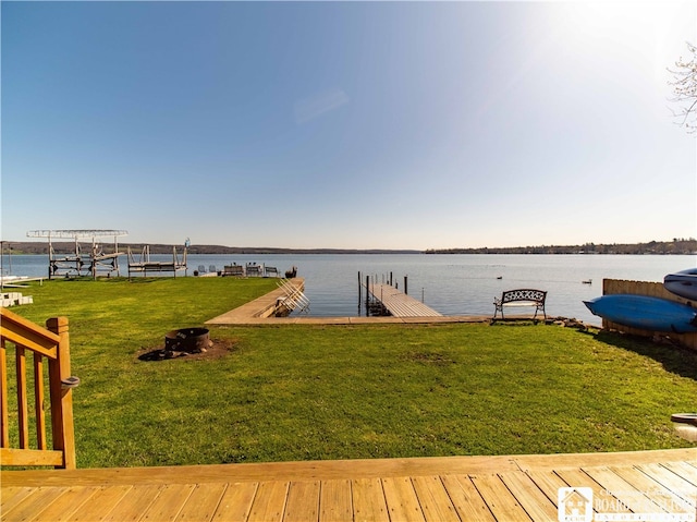 view of dock featuring a water view and an outdoor fire pit