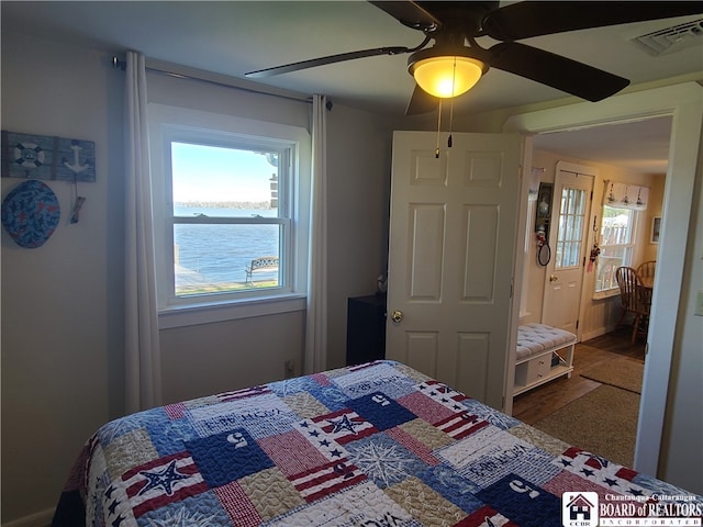 bedroom featuring ceiling fan and multiple windows