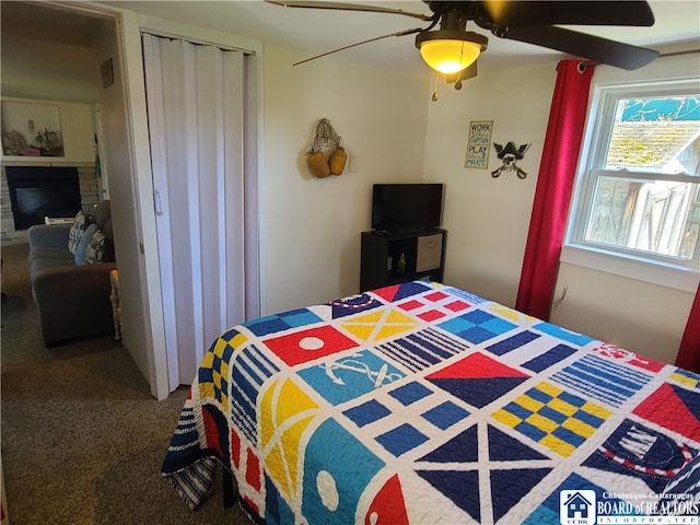 carpeted bedroom with a closet and ceiling fan