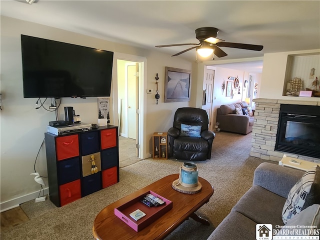 living room featuring a fireplace, ceiling fan, and carpet flooring