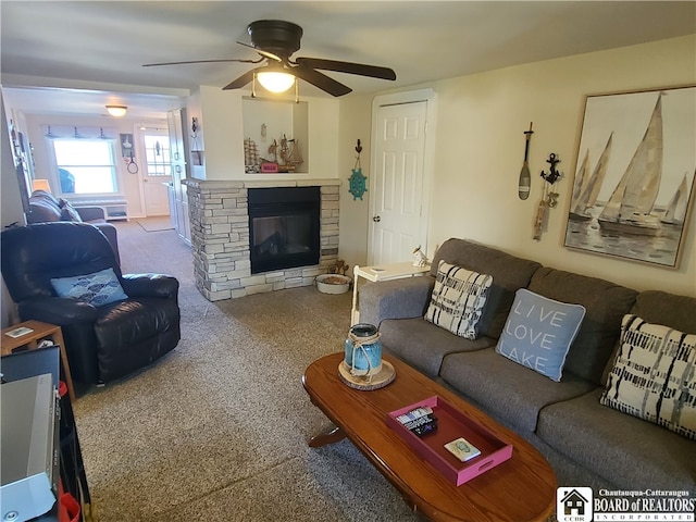 living room with ceiling fan, carpet floors, and a fireplace