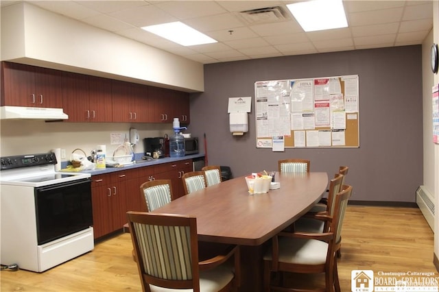 kitchen featuring light hardwood / wood-style flooring, white electric stove, and a paneled ceiling