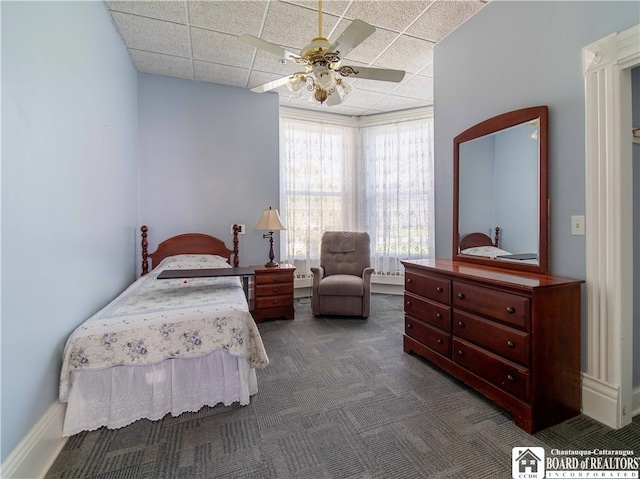 carpeted bedroom with a drop ceiling and ceiling fan