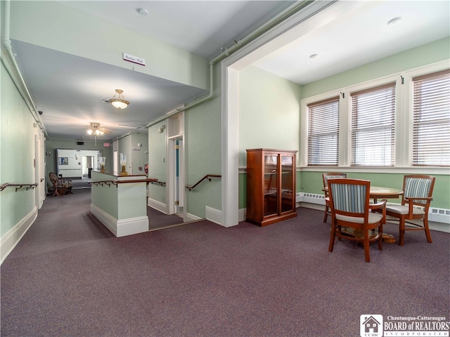 interior space featuring carpet floors and a baseboard heating unit