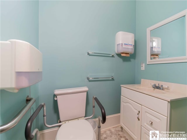 bathroom featuring vanity with extensive cabinet space, toilet, and tile floors