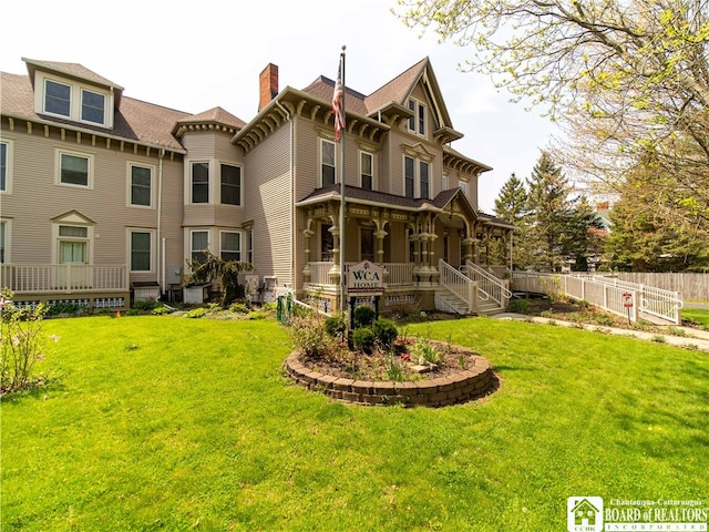 back of property featuring a porch and a lawn