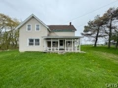 rear view of house with a yard