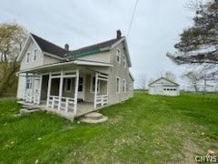 rear view of property with a lawn