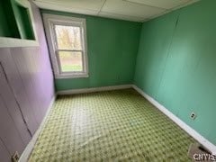 unfurnished room with a paneled ceiling