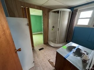 bathroom with a drop ceiling and tile floors